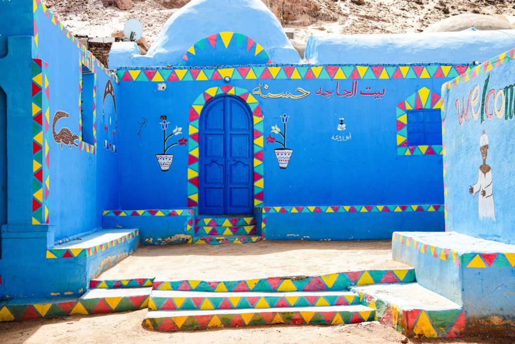 a blue building with steps painted in different colors
